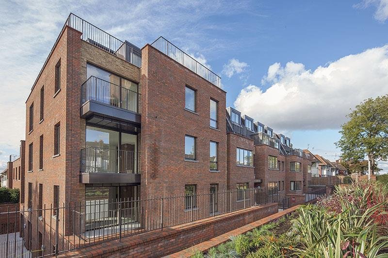Exterior view of The Beaumont, a luxury apartment building in NW11, featuring modern architecture, balconies
